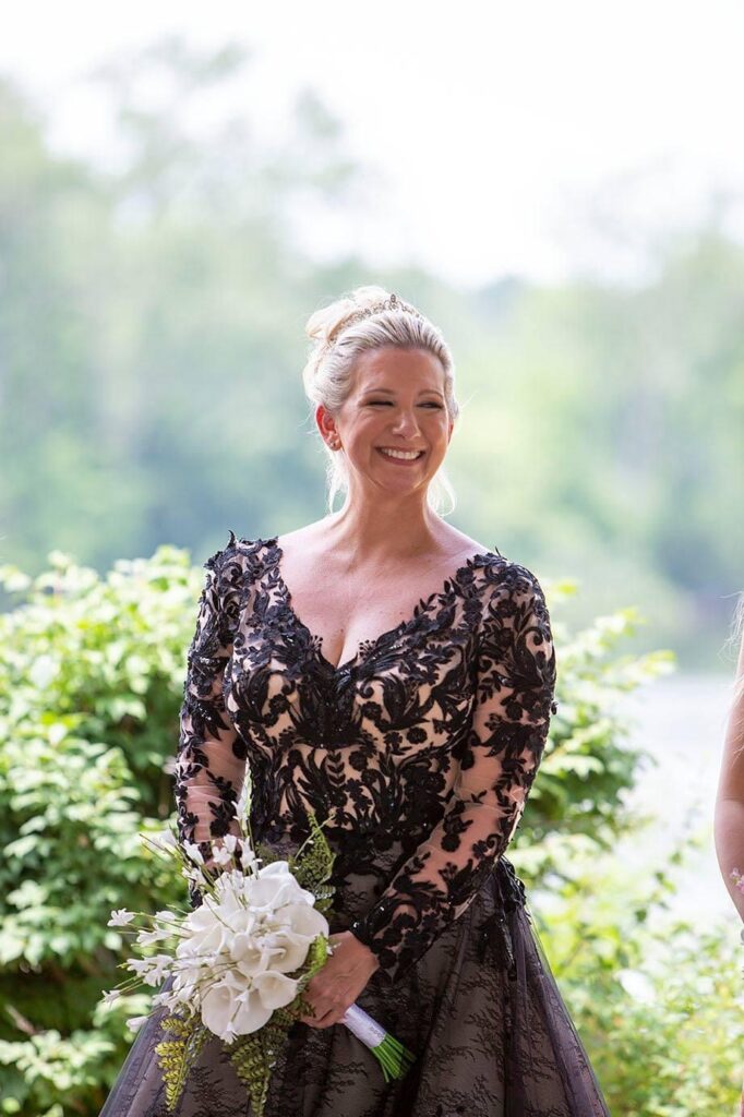 Beautiful Belleville Michigan bride smiling during their lakeside wedding ceremony.