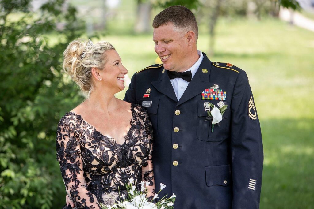 Michigan's Belleville Lake wedding couple smiling at each other.