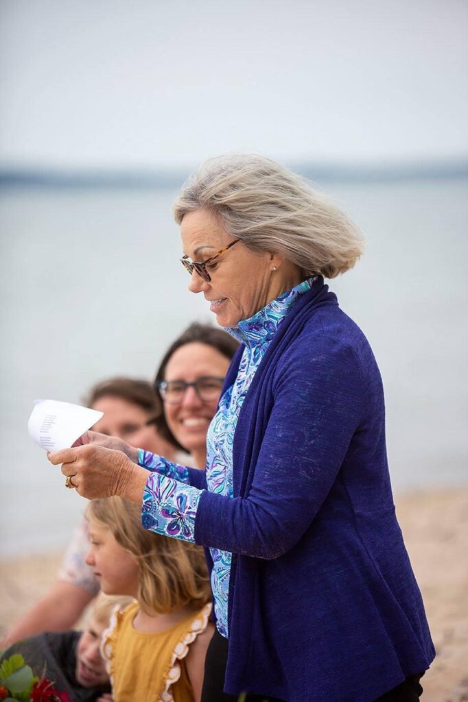 A guest reads song lyrics during the up north Michigan LGBTQ wedding