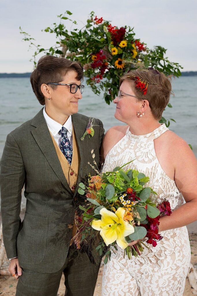 Grand Traverse Bay wedding couple smiles at each other.