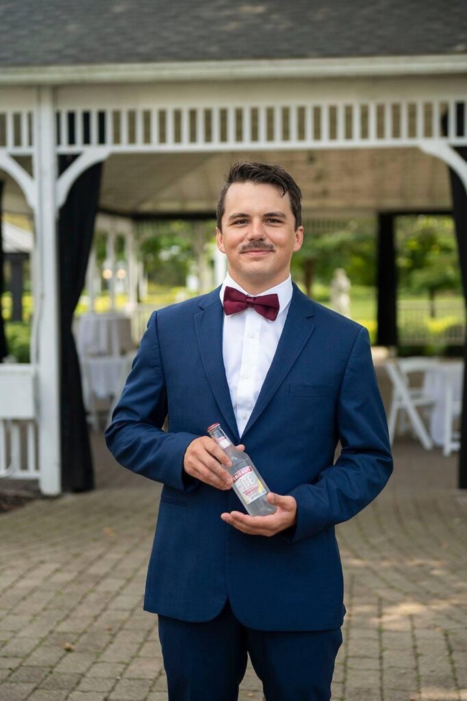 Best man at Saline Michigan Wedding prepares to "ice" the groom.