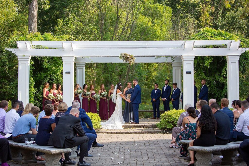 Wellers wedding party stands during the ceremony along the Raisin River.