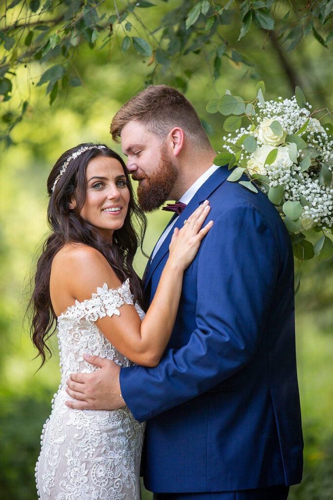 Wellers Carriage House wedding photographer captures groom about to kiss bride.