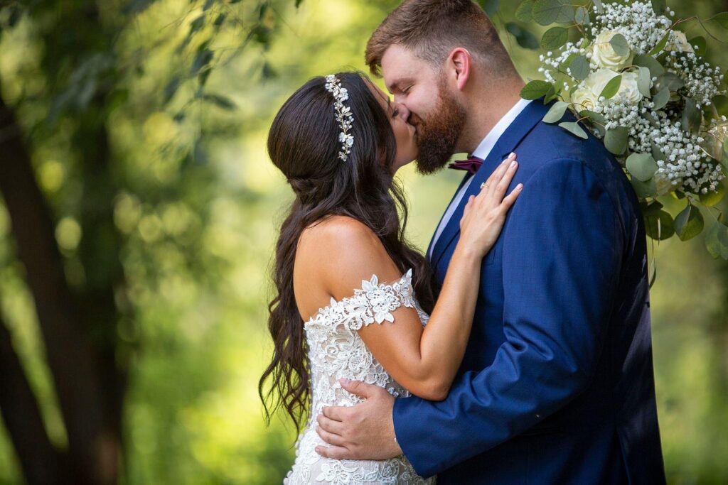 Couple shares a kiss after their Wellers Carriage House wedding.