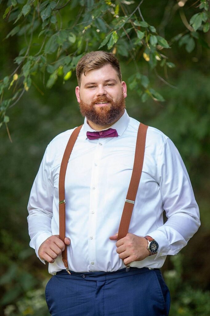 Groom poses for Livingston County wedding photographer Natalie Mae in Saline Michigan.