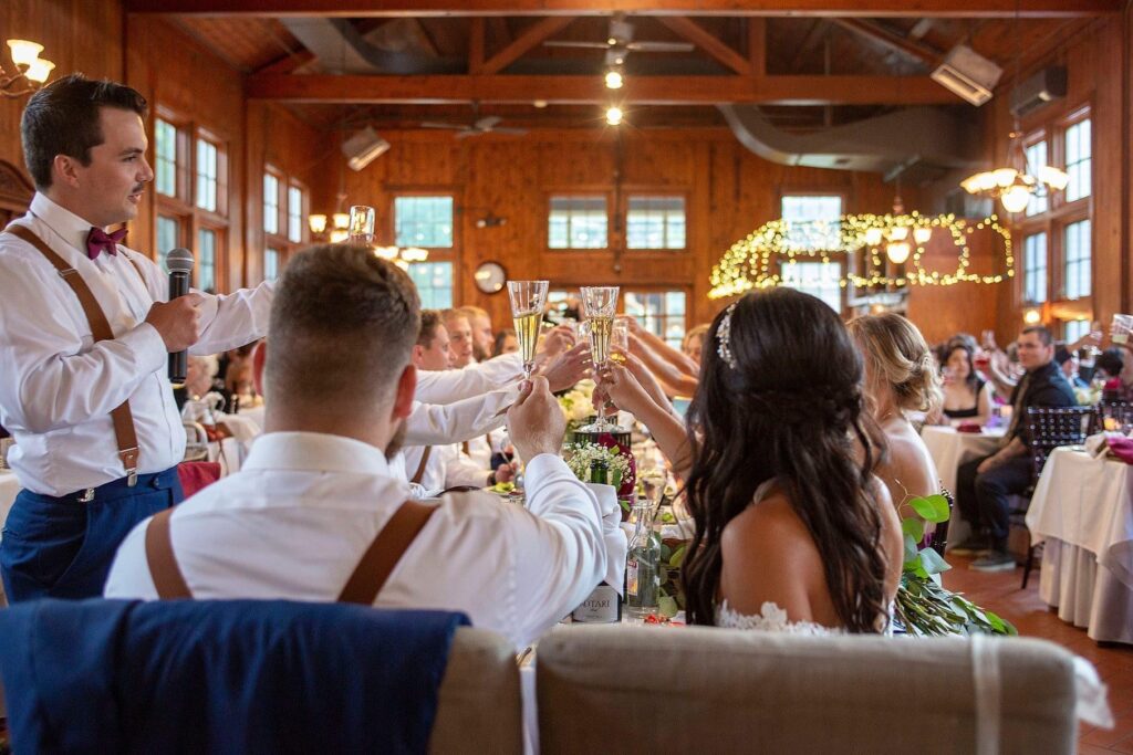 Saline Michigan wedding couple klinks glasses during a toast.