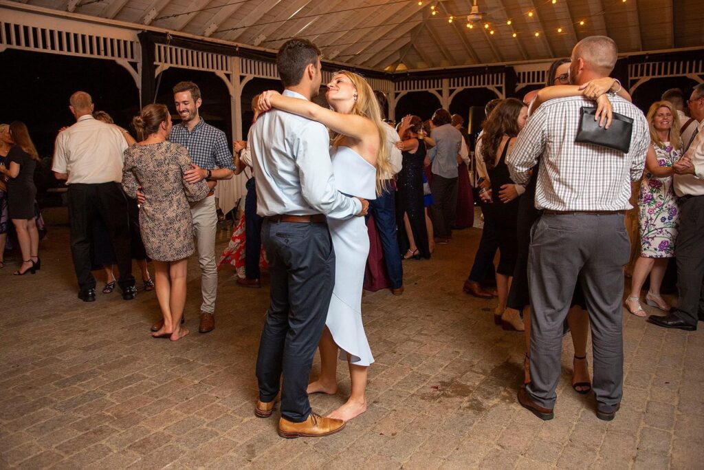 Saline wedding guests dance together.