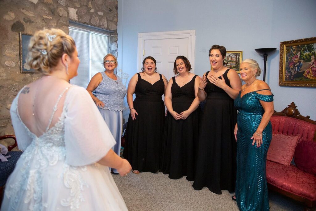 First look between bride and bridesmaids at Castle Farms wedding.