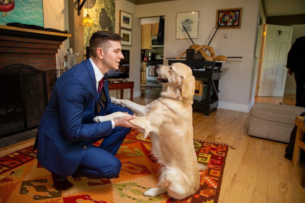 Groom hanging with his golden retriever at an AirBNB in Charlevoix Michigan.