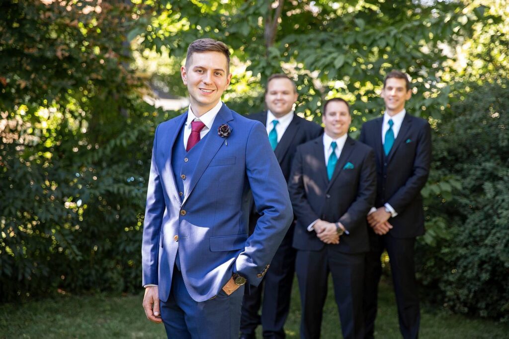 Groom and groomsmen pose before their Charlevoix wedding.