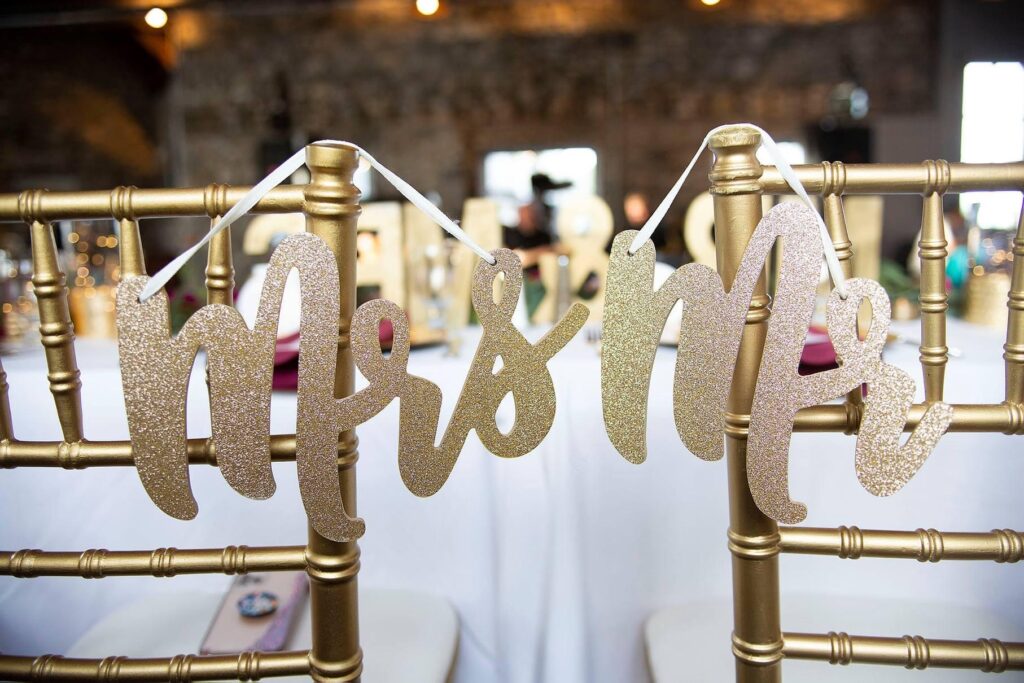 Mr and Mrs signs hang from back of Chiavari chair.