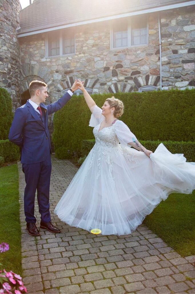 Bride twirls in the middle of an English garden at Castle Farms in Charlevoix Michigan.