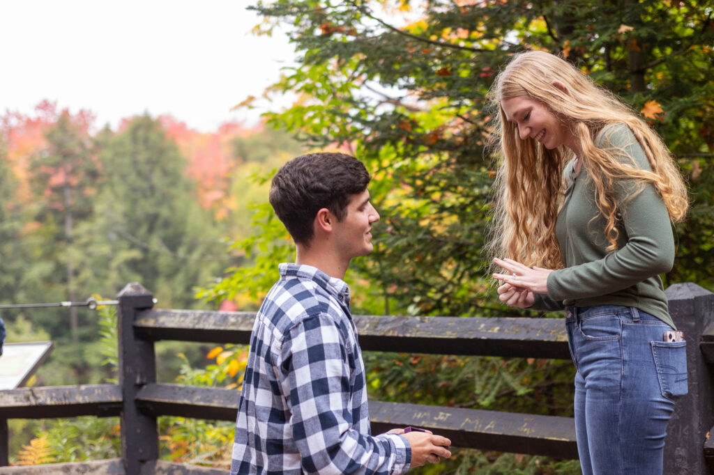 Kassidy looking at her new engagement ring as Tahquamenon Falls photographer captures her surprise proposal.