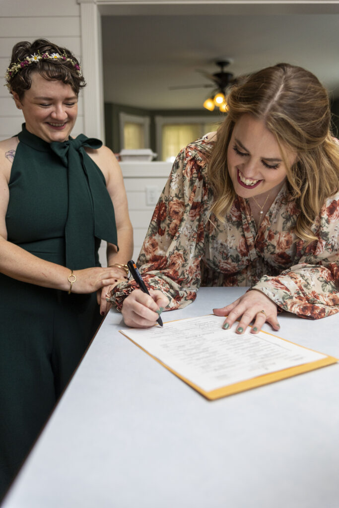 Upper Peninsula wedding couple signs their marriage license.