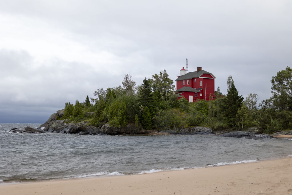 The Marquette Harbor Lighthouse with a stormy sky in the background. Perfect moody weather for a Marquette wedding photographer!