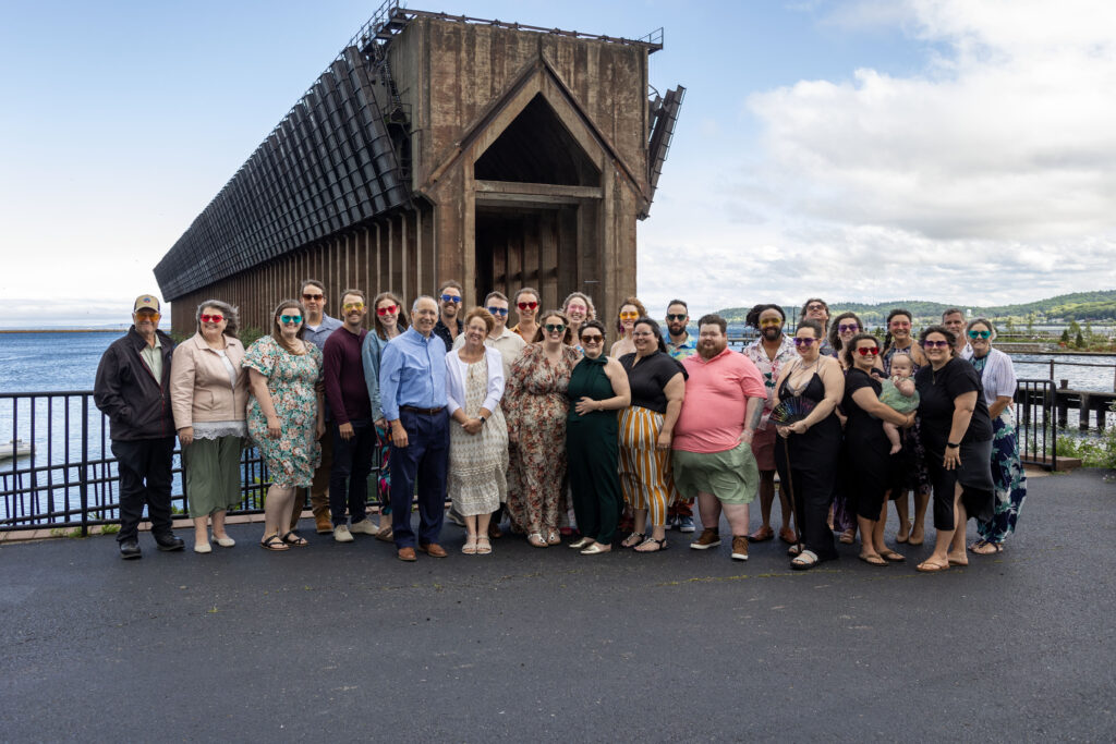 Marquette wedding guests pose for a family photo in front of the Ore Dock.