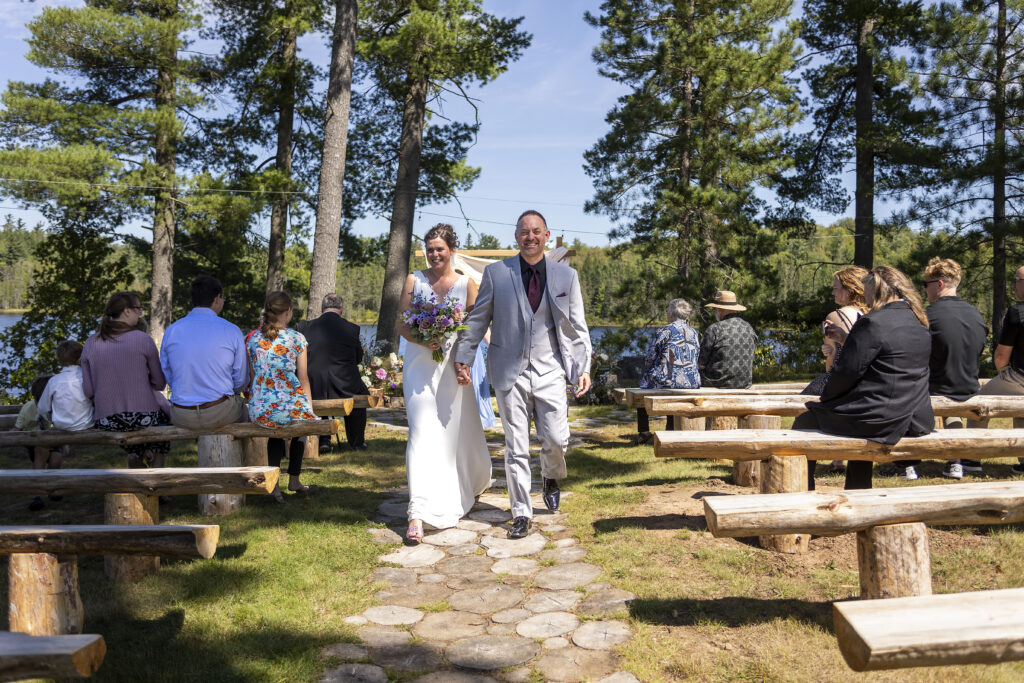 Up north wedding photographer captures couple as they walk down the aisle.