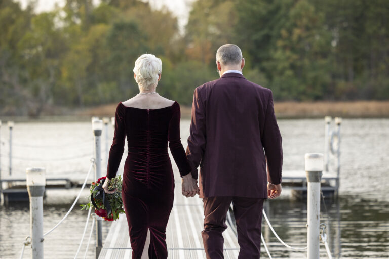 Dexter Michigan wedding photographer photographs couple walking down the dock.