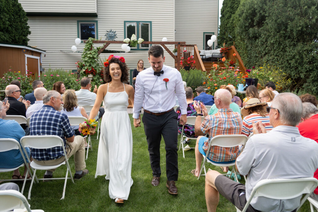 Pinckney Michigan micro wedding photographer takes photos of a couple walking down the aisle