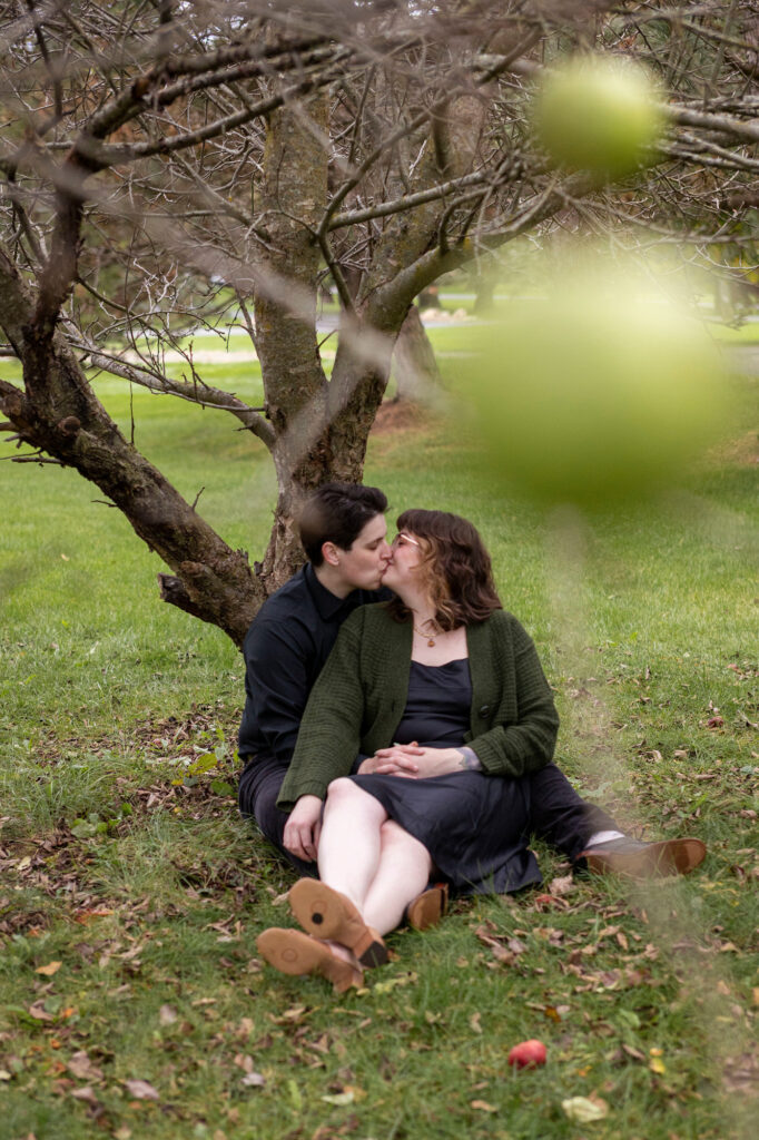 Dexter proposal photographer has couple cuddle underneath an apple tree