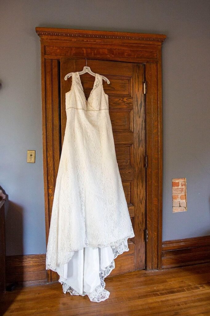 Wedding dress hangs on door at Turner Dodge House