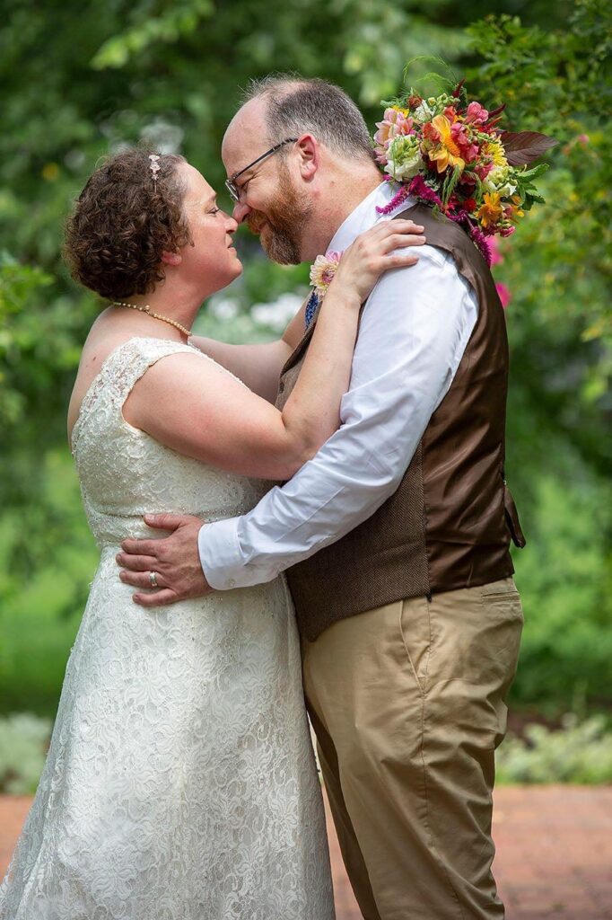 Couple kisses in the garden ceremony area of the Turner Dodge House