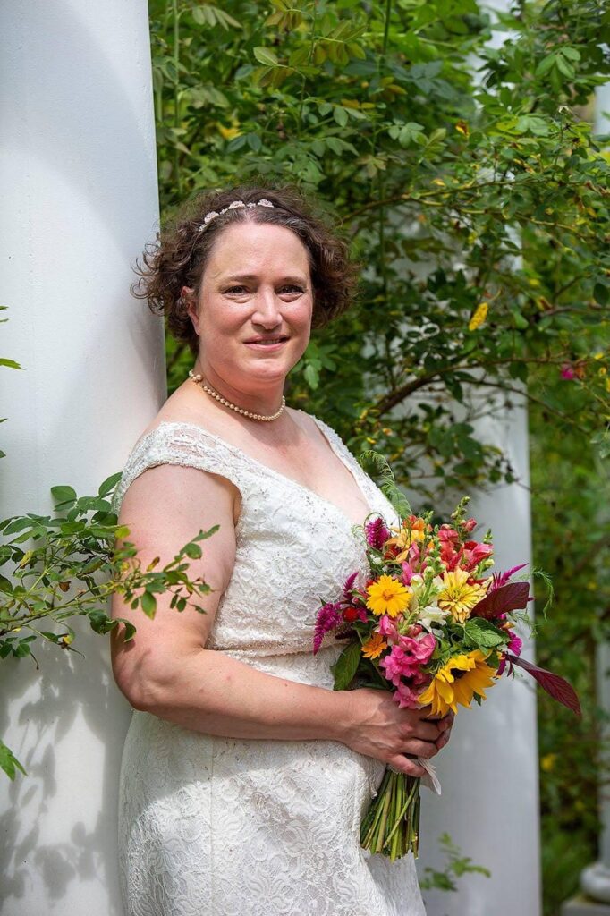 Bride leans against the pergola