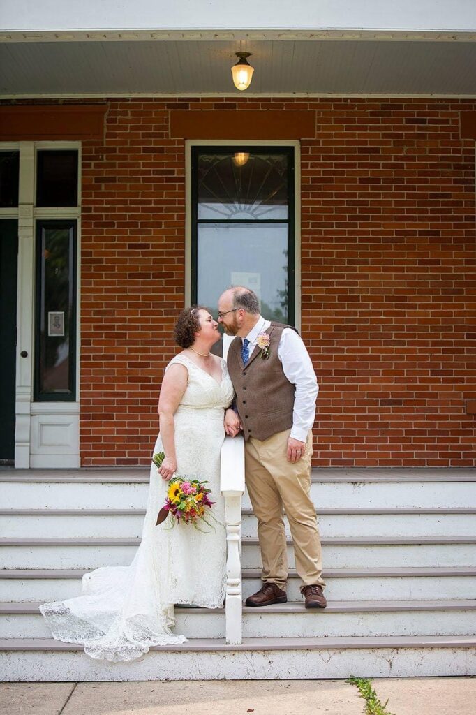 Couple kisses on the steps of their Turner Dodge House wedding