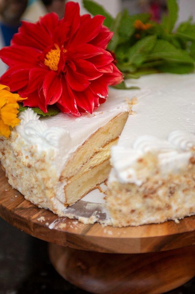 Wedding cake with slice cut out of it.