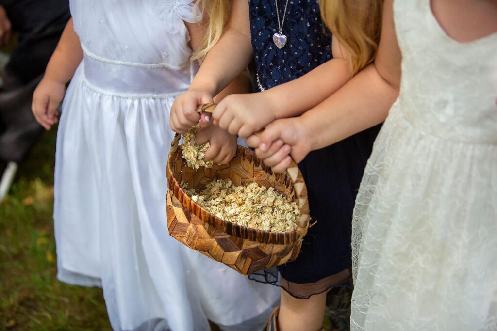 Flower girls holding basket of dried flower petals for Brooklyn Michigan wedding