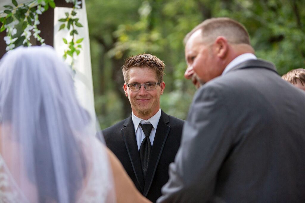 Groom tears up at the sight of his bride during Irish Hills barn wedding.