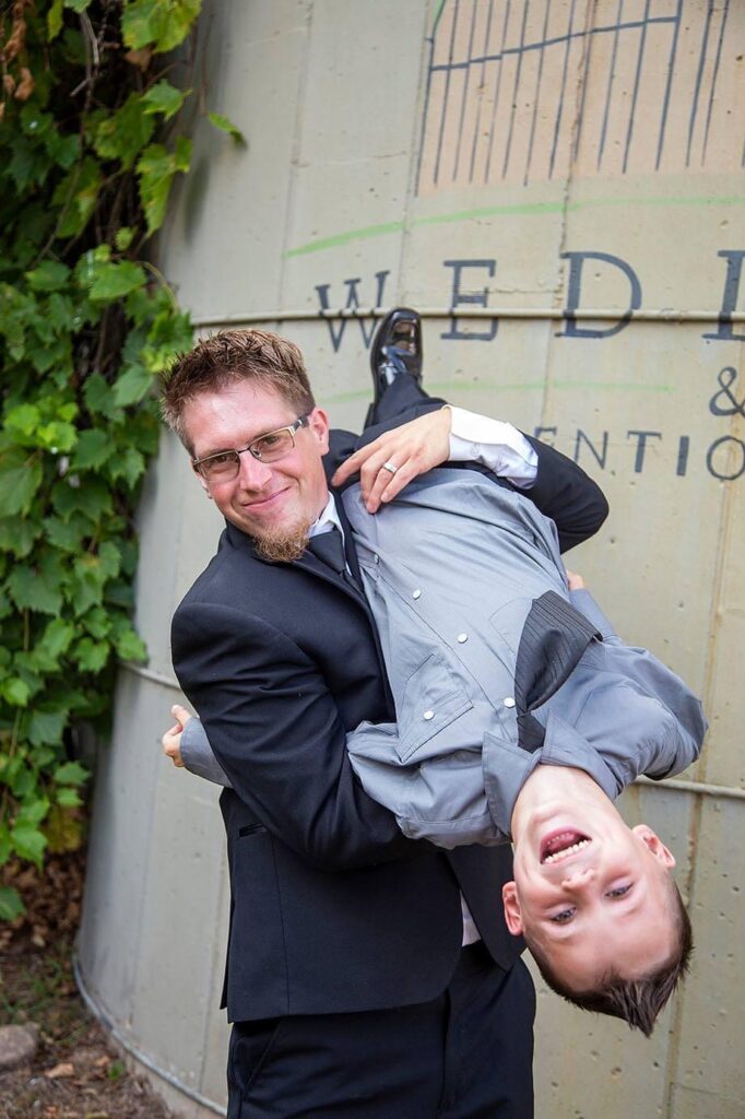 Groom tips nephew upside down playfully