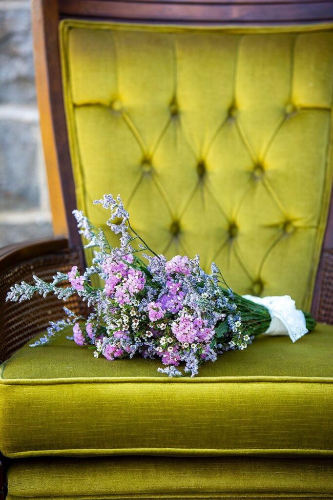 Purple bouquet on green velvet chair Michigan VRBO wedding