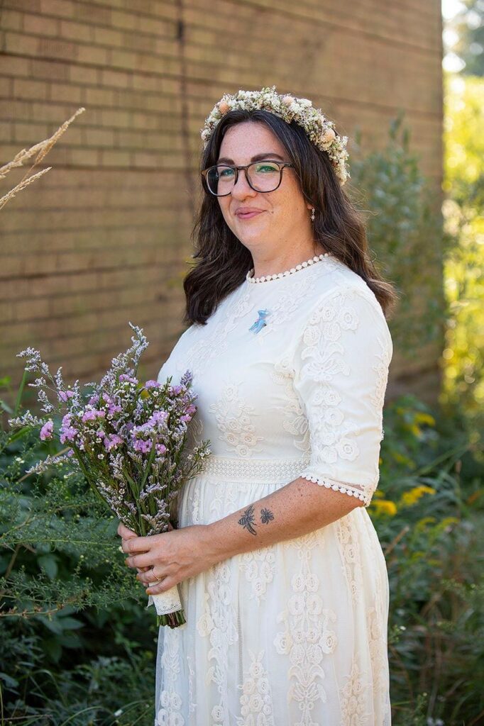 Queer bride poses with wedding boquet