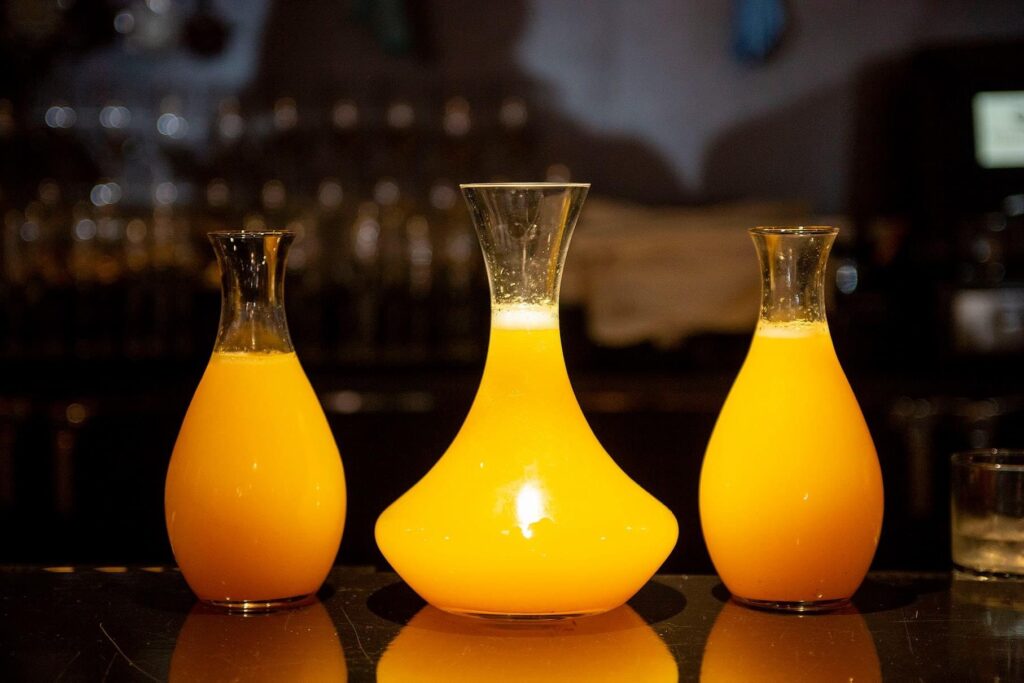 Carafe of liquid illuminated on the bar counter