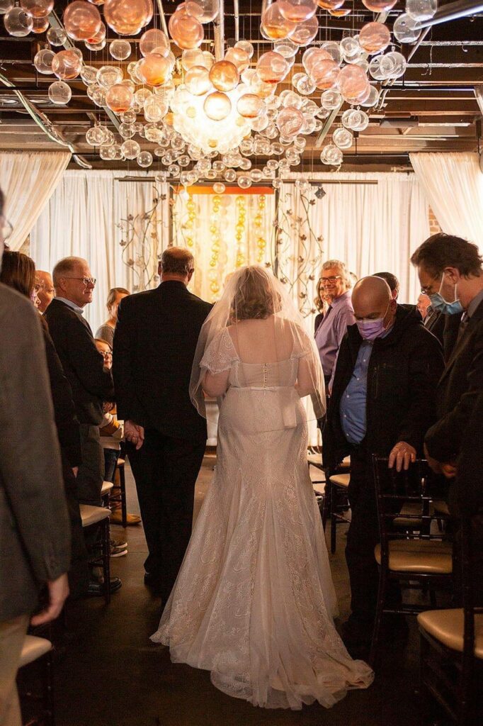 Bride walks down the aisle at Vinology wedding in Ann Arbor