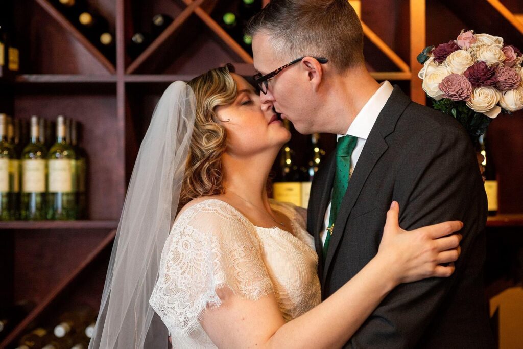 Bride and groom kissing at their Vinology wedding.