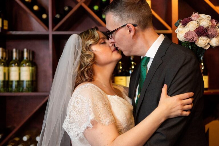 Bride and groom kissing at their Vinology wedding.