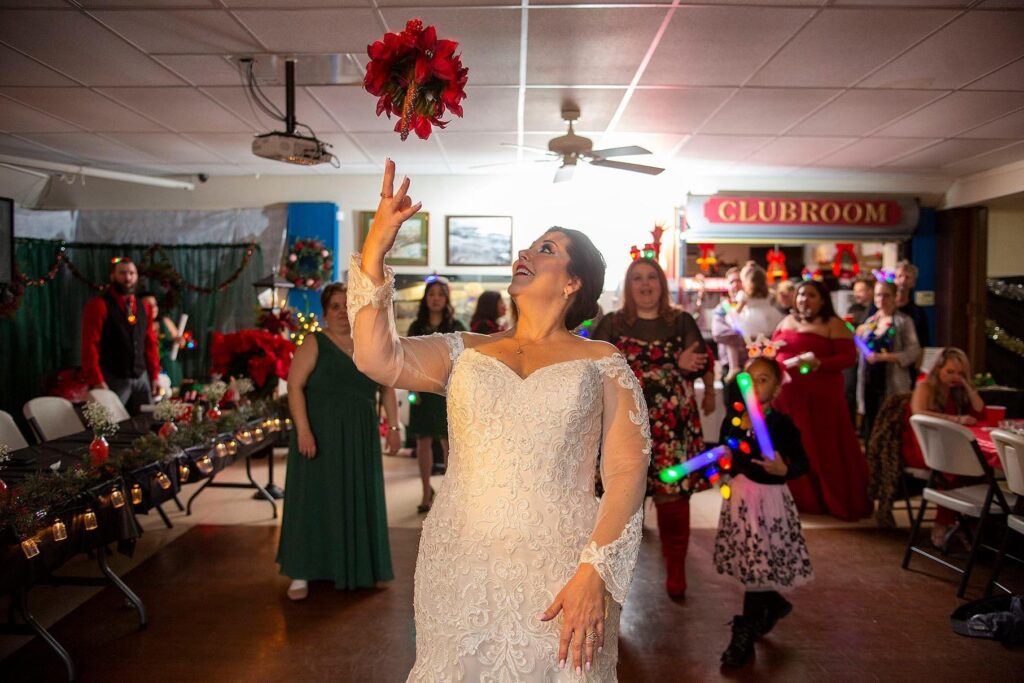 Bride tosses bouquet at their winter Pinckney wedding