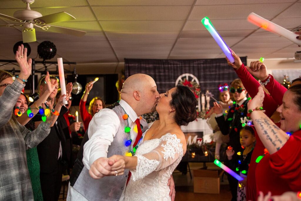 Pinckney wedding couple kisses as guests wave lighted