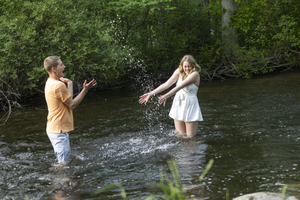 Dakota and Talia splashing each other in the river at Hudson Mills Metropark