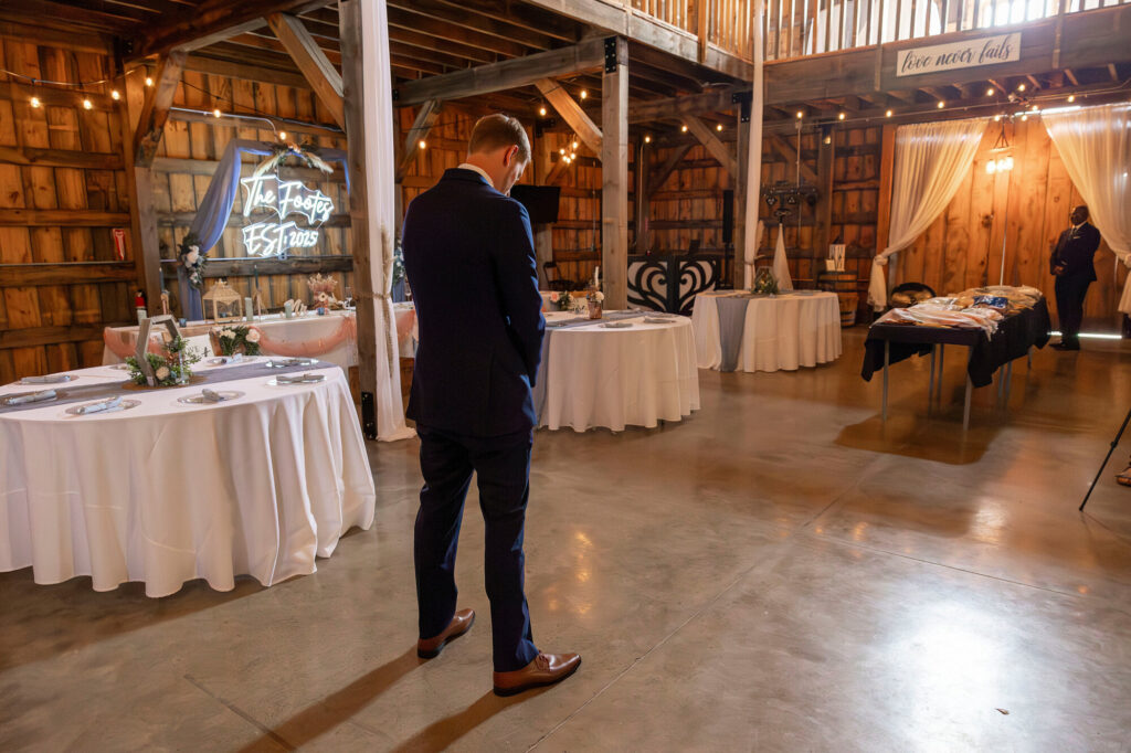 Groom waiting for bride for a first look at the Rustic Wedding Barn in Allen, MI.