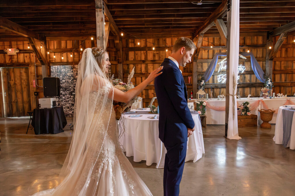 Couple exchanging vows inside The Rustic Wedding Barn