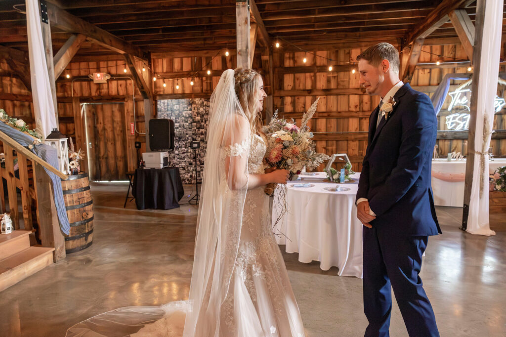 Couple exchanging vows inside The Rustic Wedding Barn