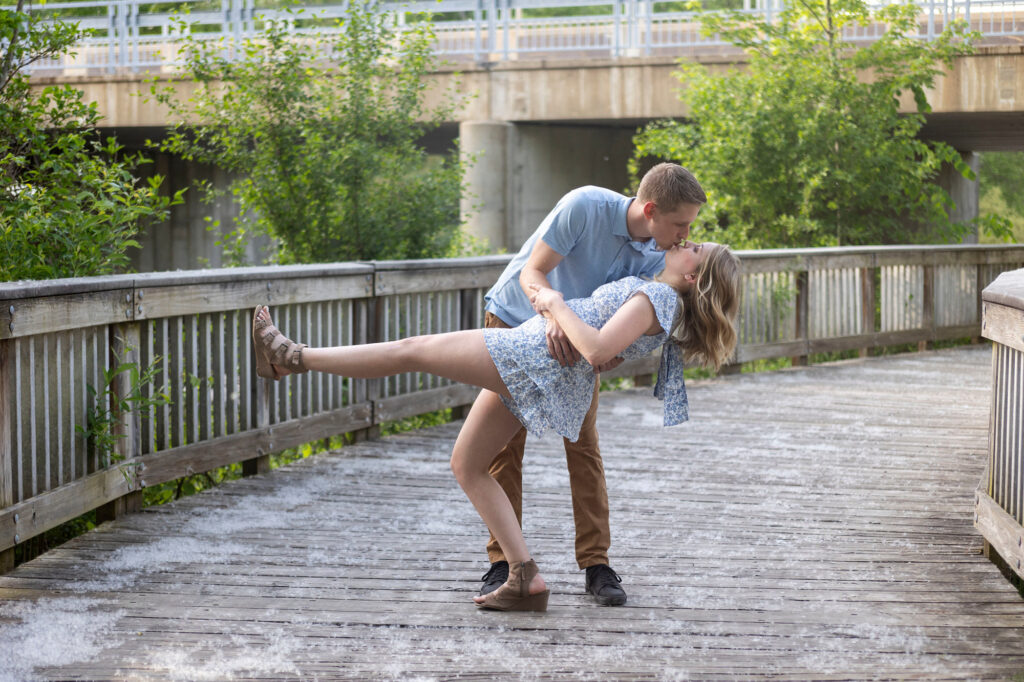Couple smiling along the Huron River with cottonwood fluff in the air