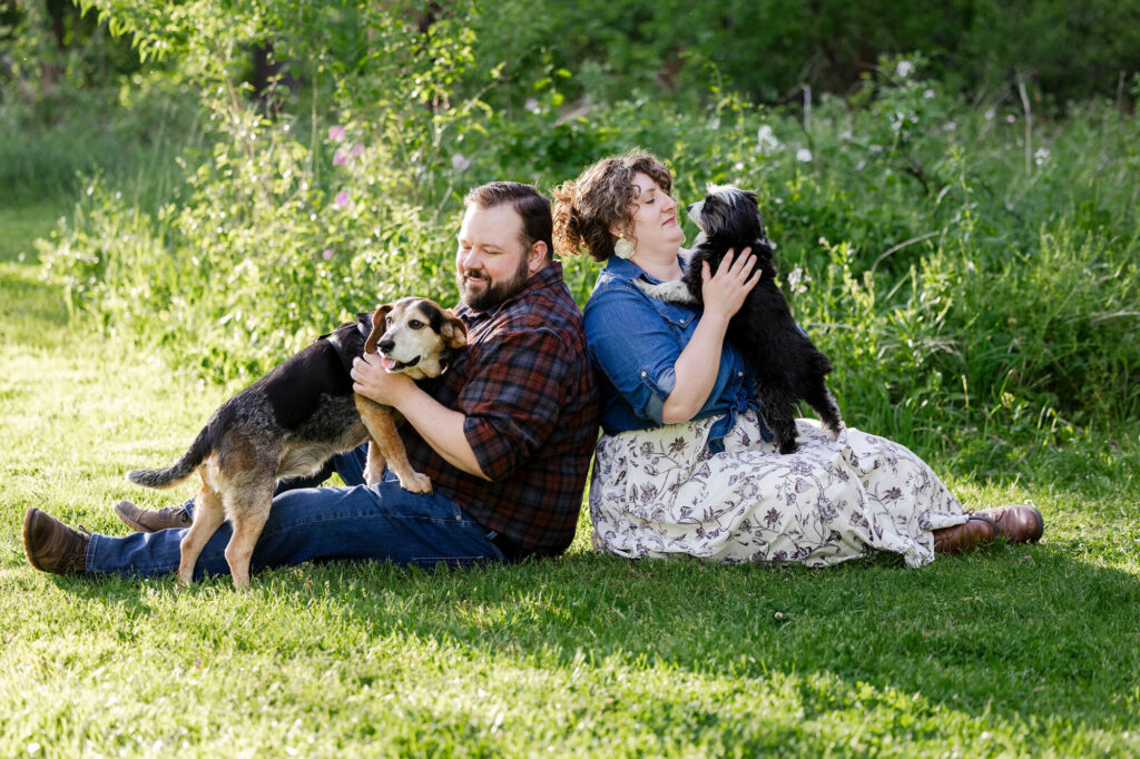 Collin holding one of the pups while Natalie gently pets the other